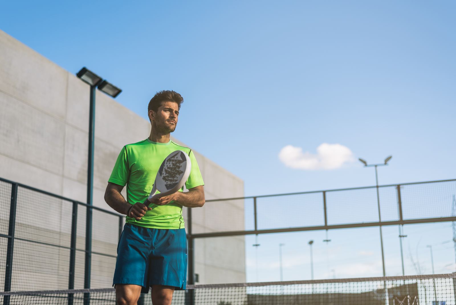 Padel player hitting a shot mid-match